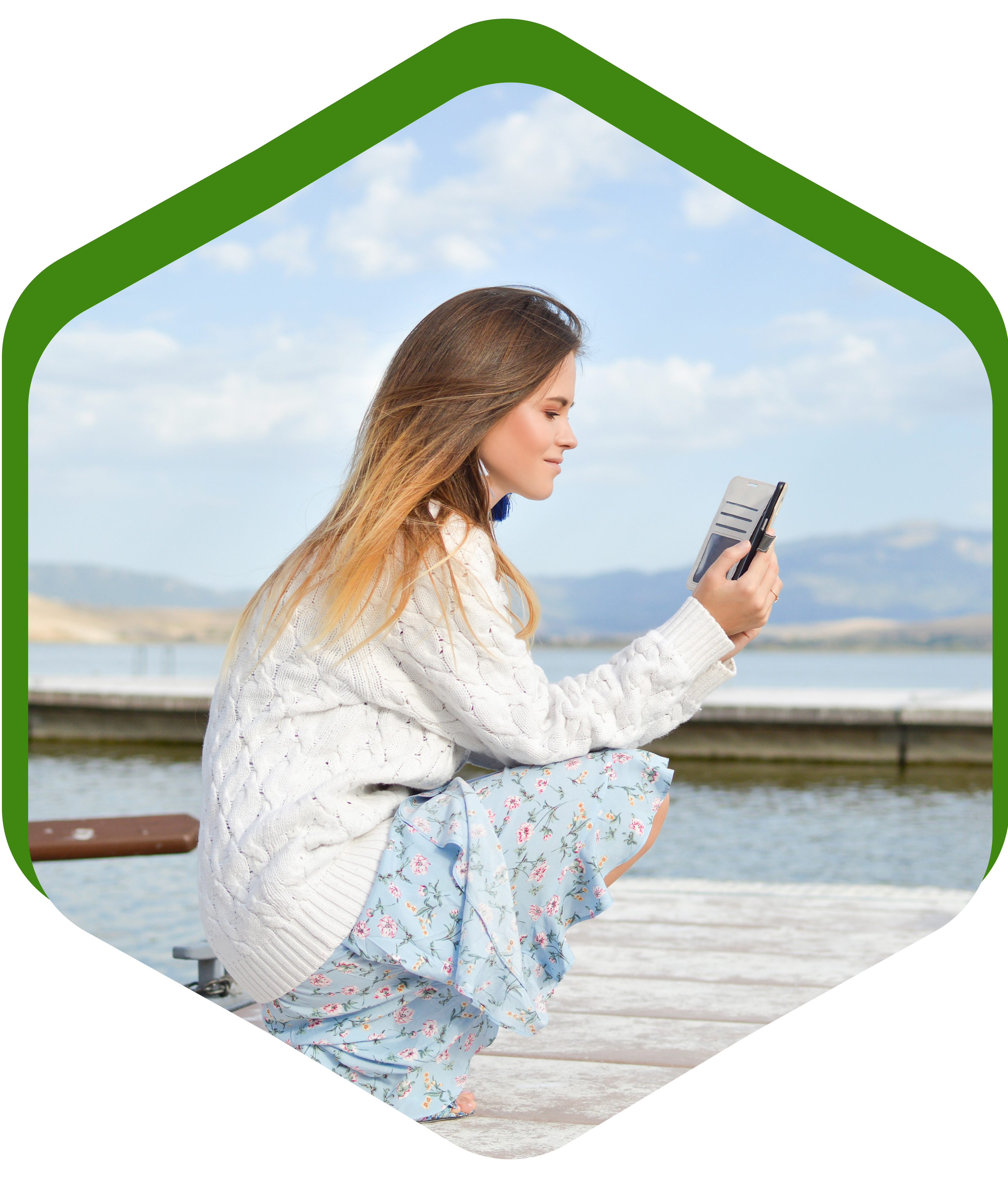 Woman using phone by lake