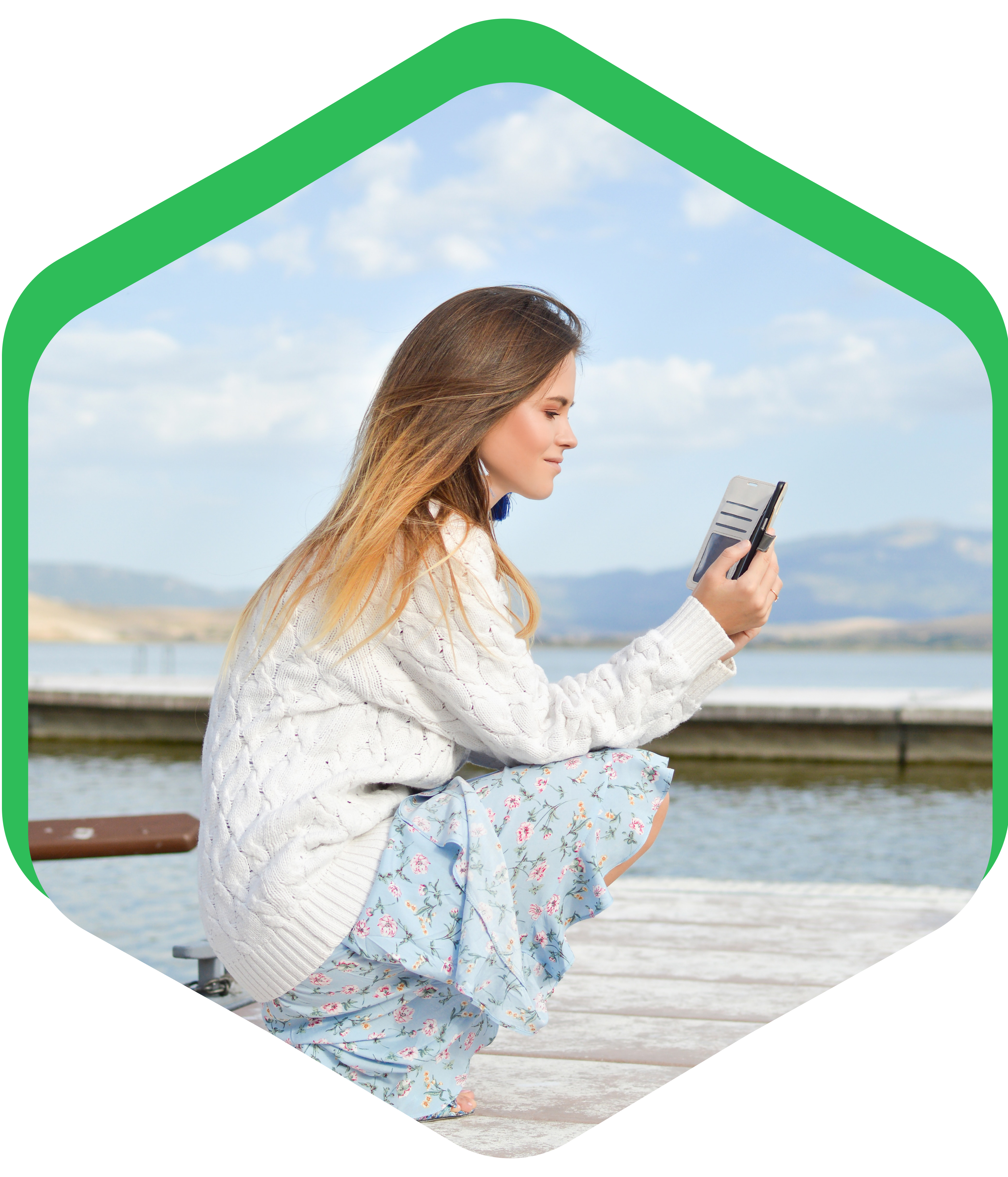 Woman using phone by lake